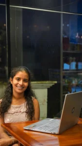 a girl siting on a table in front of laptop digital marketer in alappuzha